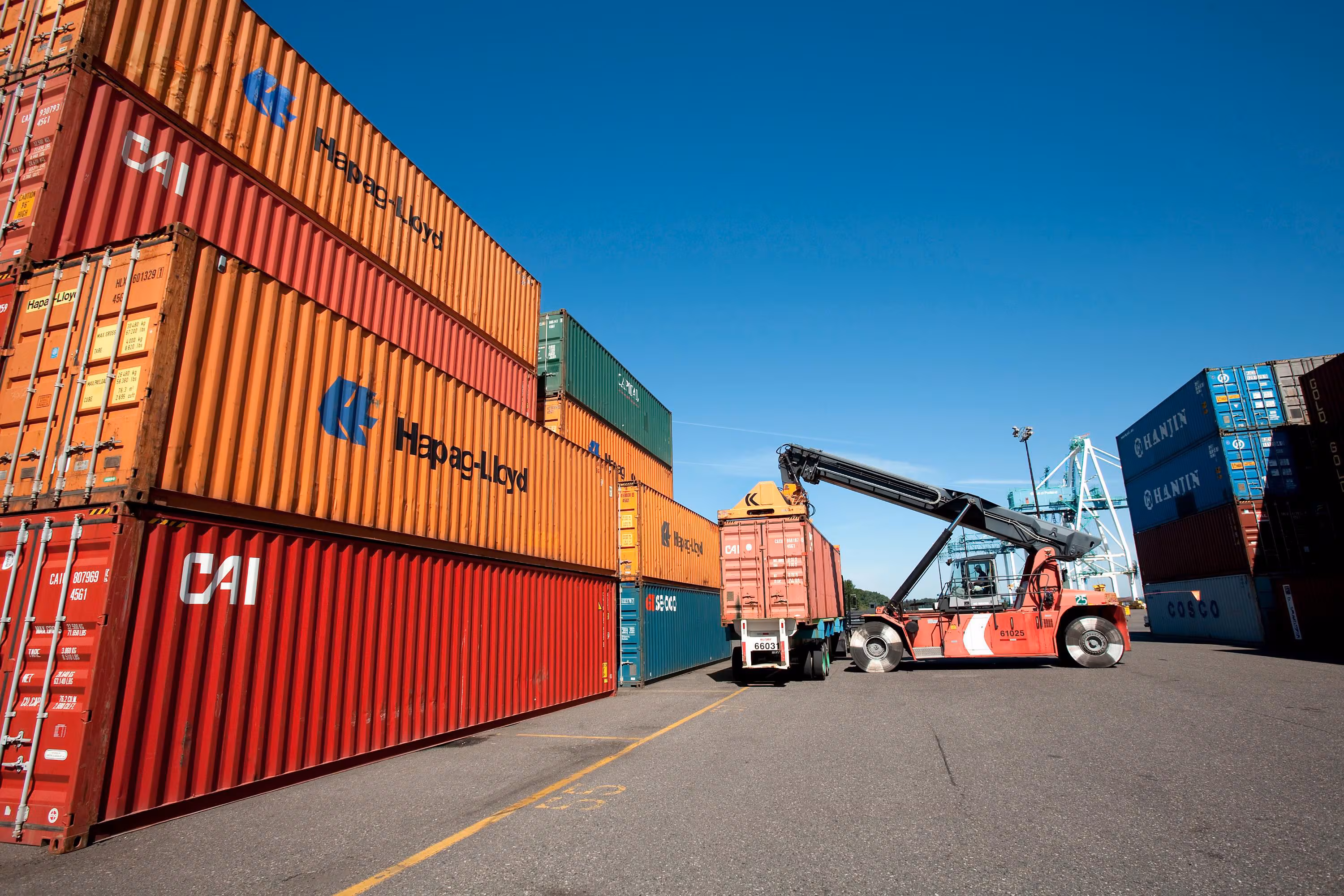 Shipping containers being moved at a port.