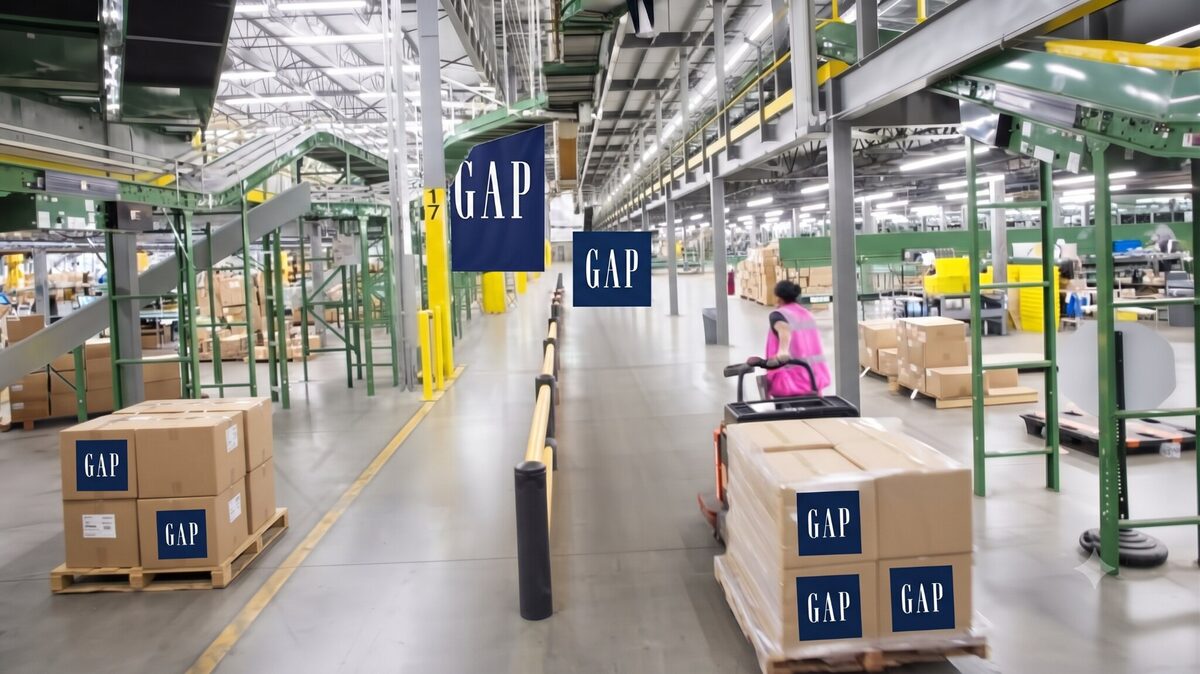 A warehouse aisle with Gap branded shipping boxes stacked on pallets.