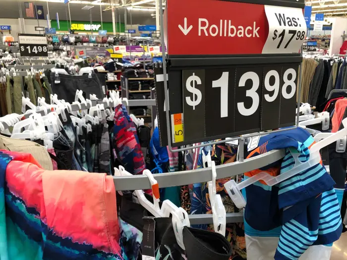 A retail clearance rack with a discounted rollback price sign.