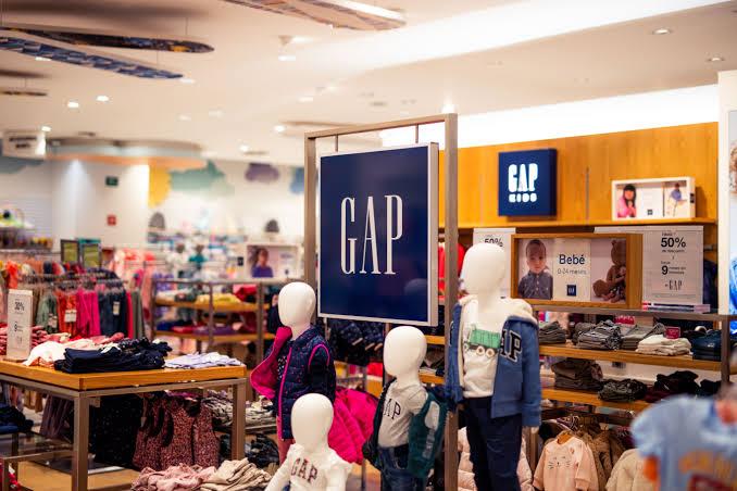 Customers browsing racks inside a Gap retail store.