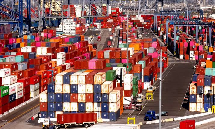 A congested shipping port packed with stacked cargo containers.